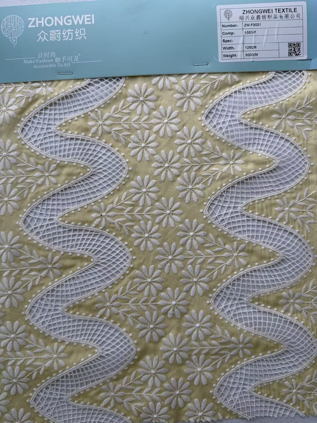 Embroidered lace applique fabric sample