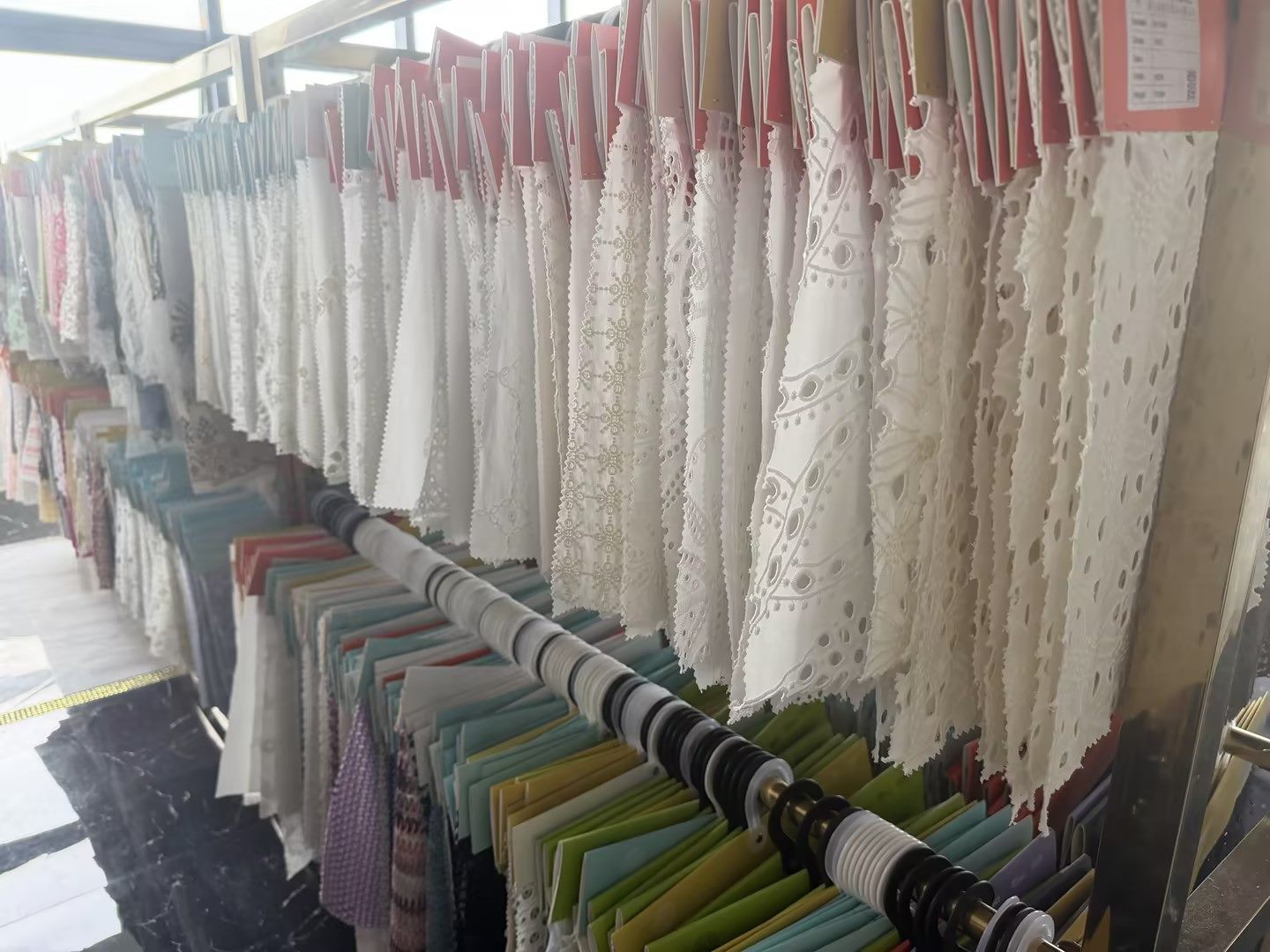 White lace fabric swatches in Zhongwei Textile sample room